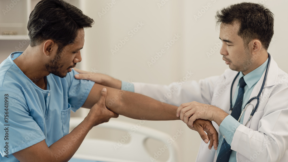Physical therapist doing physical therapy on male patient with muscle injury in arm, healthy medical treatment concept. Professional male therapist working in rehabilitation center Physical therapist doing physical therapy on male patient with muscle injury in arm, healthy medical treatment concept. Professional male therapist working in rehabilitation center