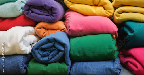Colorful pile of freshly folded laundry from the laundry room © Issah