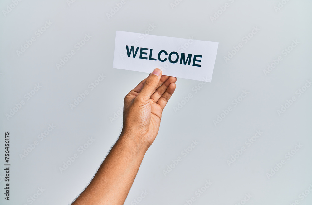 Hand of caucasian man holding paper with welcome word over isolated white background Hand of caucasian man holding paper with welcome word over isolated white background