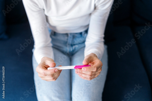Woman checking at result on confirmed pregnancy test