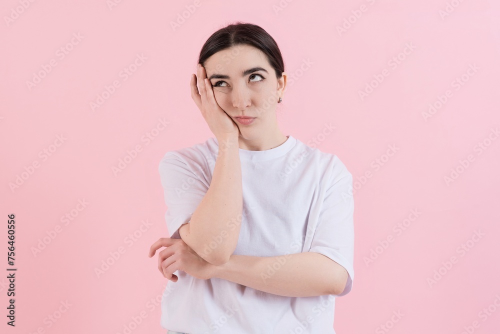 Portrait of attractive sad bored Caucasian young brunette woman in casual clothes isolated on pink studio background. Portrait of attractive sad bored Caucasian young brunette woman in casual clothes isolated on pink studio background.