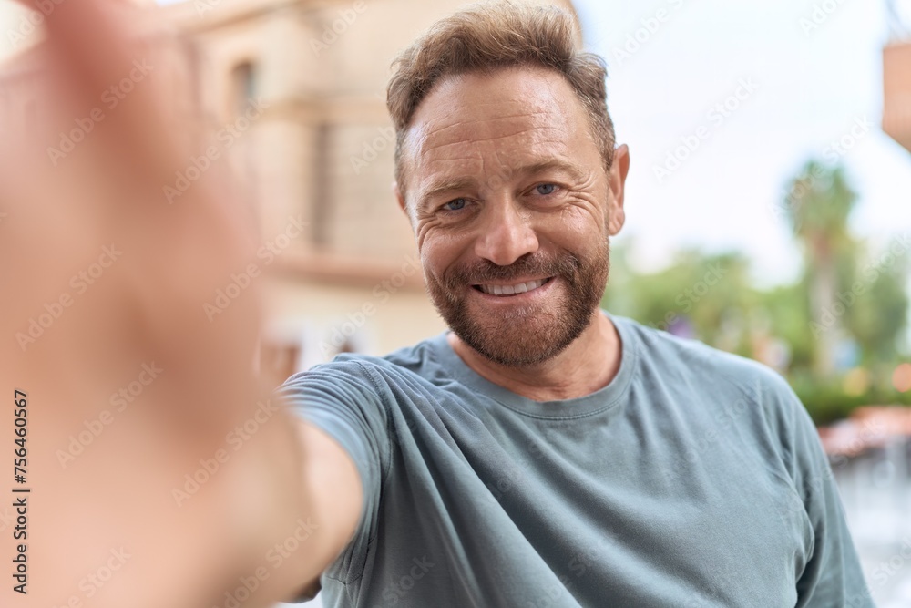 Middle age man smiling confident making selfie by camera at street Middle age man smiling confident making selfie by camera at street