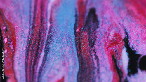 Glitter paint mix. Marble ink texture. Defocused pink blue color shimmering particles fluid blend flow motion abstract art background.