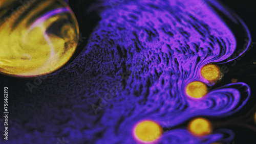 Paint bubbles. Glitter ink water. Defocused neon purple golden yellow color shiny particles oil liquid mix wave flow motion abstract art background.