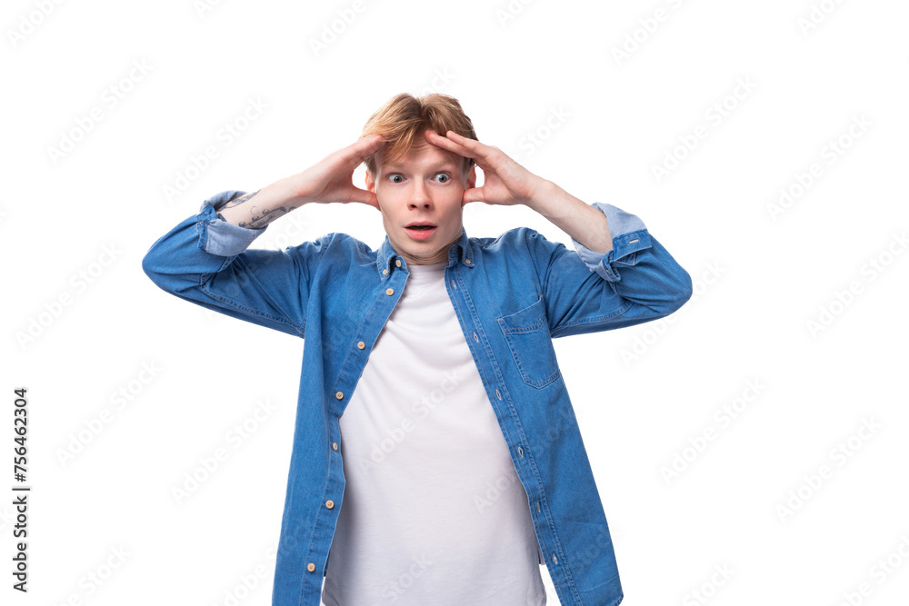 portrait of a pensive caucasian red-haired guy in a denim blue shirt portrait of a pensive caucasian red-haired guy in a denim blue shirt