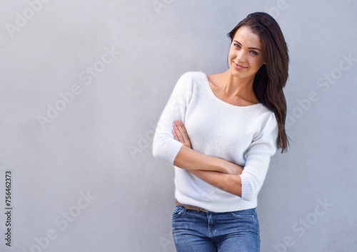 Portrait, arms crossed and woman in studio with mockup space, fashion or trendy style on gray background. Female person, smile and happy with confidence or stylish or cool in casual outfit or sweater