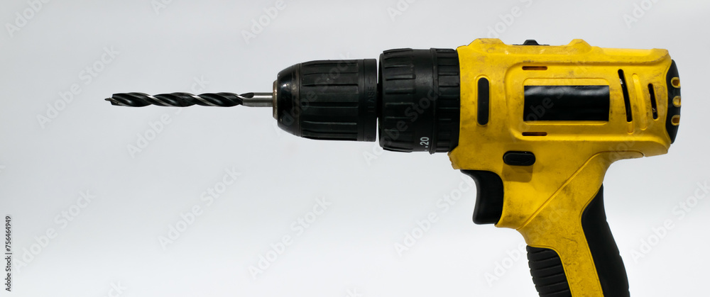 Old screwdriver with drill bit on white background. Old screwdriver with drill bit on white background.