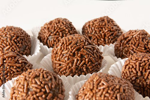 Brigadeiro brazilian chocolate truffle balls candy and chocolate flakes front view clean background