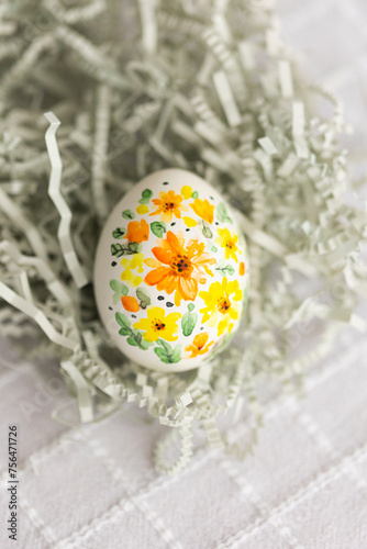 The symbol of Easter - painted egg with colorful handmade spring flowers