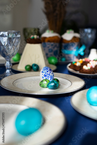 Holiday table laid for Easter celebration with Easter cakes  cookies in shape of nests  tradition cottage cheese Easter and colorful hand-pained Easter eggs