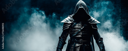 Mysterious figure of an assassin dressed in a hood and medieval armor on a black foggy background.