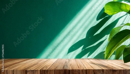 wood table green wall background with sunlight window create leaf shadow on wall with blur indoor green plant foreground panoramic banner mockup for display of product eco friendly interior concept