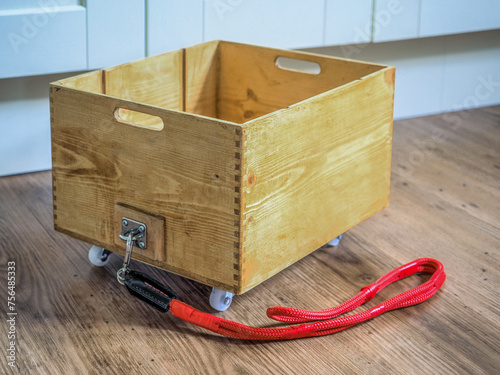 upcycled wooden wine crate box to create a utility trolley with red chord pull handle