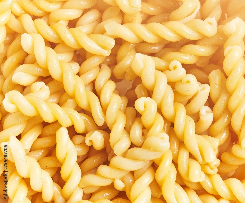 Close-up view of cooked twist pasta filling the frame for a culinary background. Close-up view of cooked twist pasta filling the frame for a culinary background.