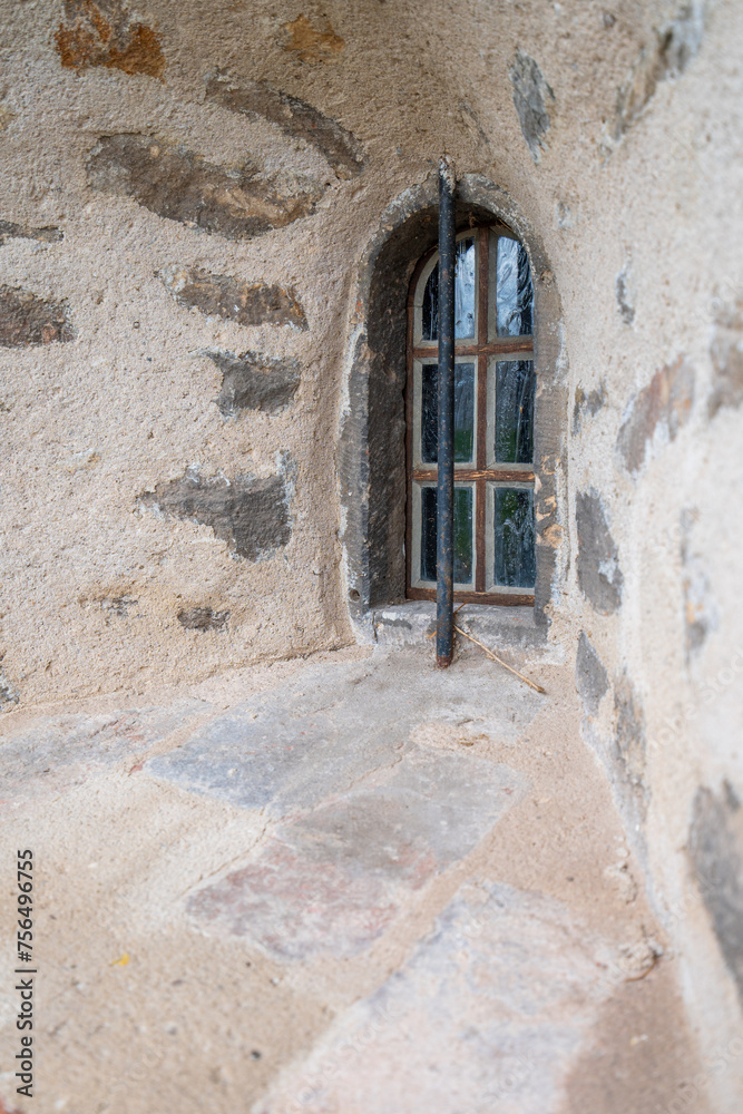 Old window at the bottom of a tower with thick walls of a former monastery in Magdeburg