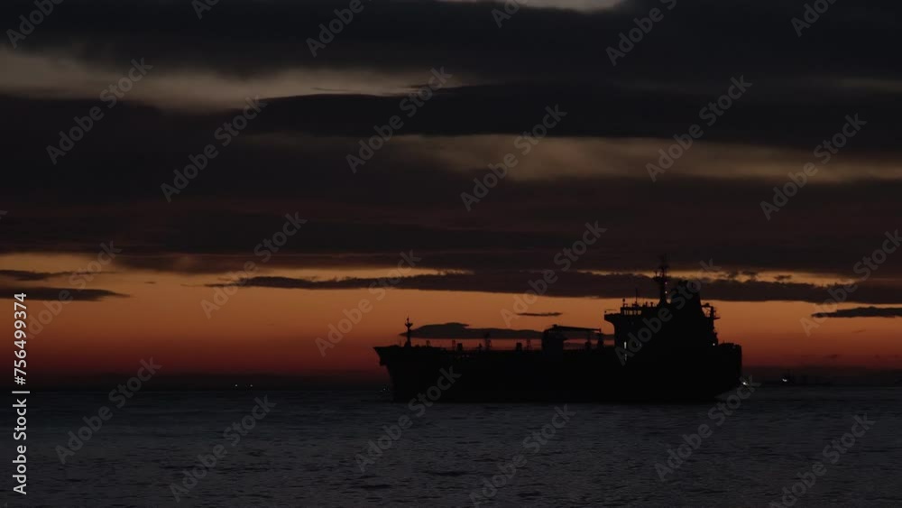 Silhouette of cargo ship going at sunset seascape Silhouette of cargo ship going at sunset seascape