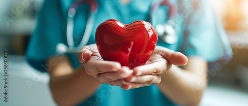 Red heart in hand close up with medical equipment Symbol of love healthy heart donation photo