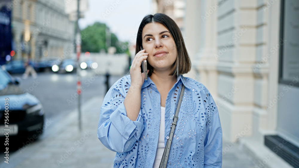 Young beautiful hispanic woman smiling happy speaking on the phone in the streets of Vienna Young beautiful hispanic woman smiling happy speaking on the phone in the streets of Vienna