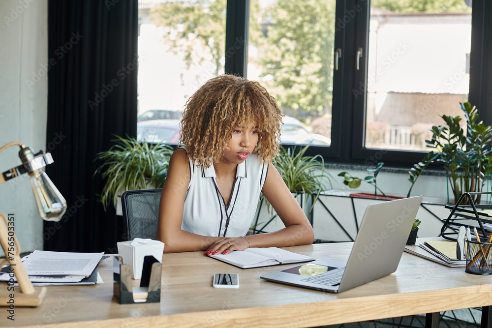 african american businesswoman looking at laptop during video call in modern office, working day african american businesswoman looking at laptop during video call in modern office, working day