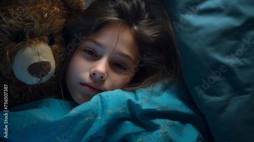 little girl sleeping peacefully with favorite toy. girl lying cuddling with favorite teddy bear