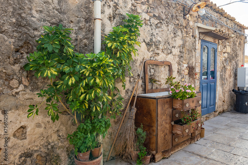 Old wooden chest of drawers on Vicolo Villadorata in Marzamemi village on the island of Sicily, Italy photo