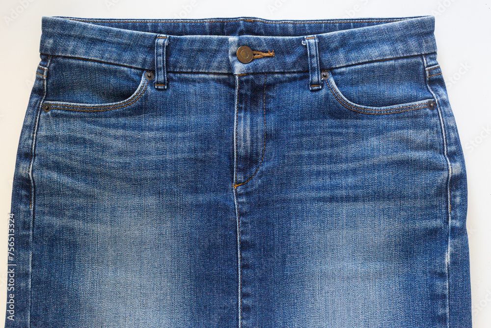 Blue jean skirt in front view on white background, closed-up studio shot.