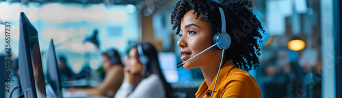 A customer support representative with a headset sitting at a call center desk photo