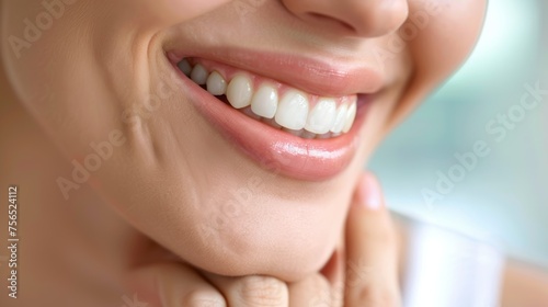 Close up shot of a woman's smile with white healthy teeth isolated on a light background. Banner for dentistry