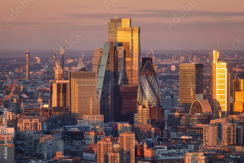 The diverse architecture of the office skyscrapers at the City of London, England, during golden sunrise