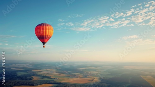 A hot air balloon drifting gracefully across the cloudless summer sky, offering panoramic views of the landscape below. © Dave