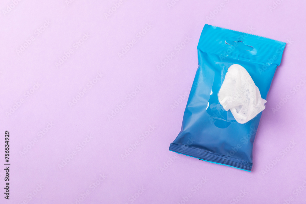 Packaging of wet wipes on a purple background. An open pack of hand and body wipes. Mockup. A clean packet of wet wipes. Design. Place for text. Copy space.