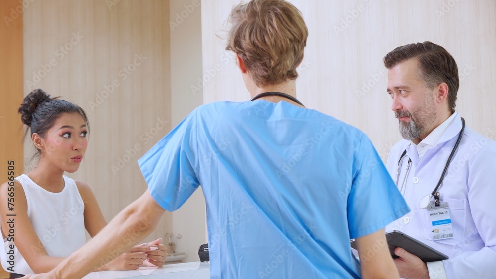 Obraz premium A happy receptionist discussing health with attentive doctor in clinic or hospital, diversity and ethnicity, team doctor talking and discussing about patient, medical and healthcare concept.