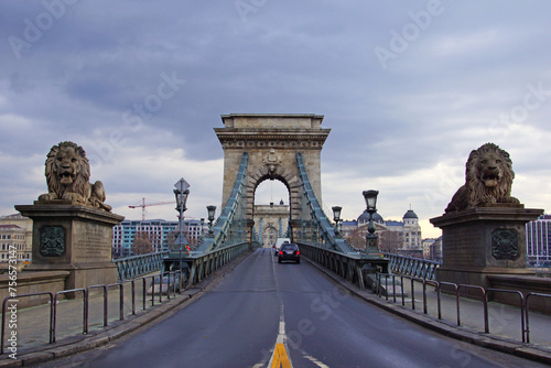 The Szechenyi Chain Bridge is a suspension bridge that spans the River Danube between Buda and Pest. The Guardian lions at each of the abutments carved in stone.