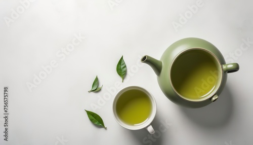 Green tea with ceramic teapot over a white texture background photo