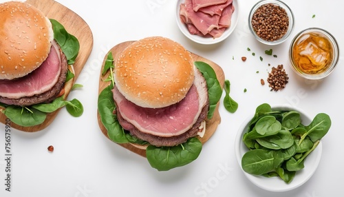 Grilled cold cuts roast beef burger sandwich with arugula and spinach.  Isolated on white background