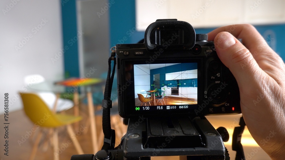 Real estate photographer taking pictures and videos at house in apartment living room with professional camera - selling home with real estate agency and home staging indoor home design