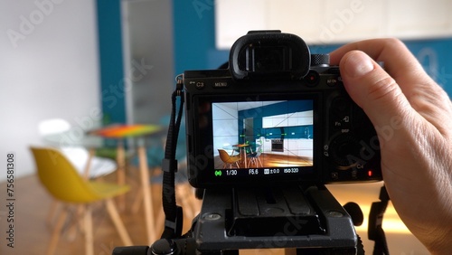 Obraz na płótnie Real estate photographer taking pictures and videos at house in apartment living room with professional camera - selling home with real estate agency and home staging indoor home design w salonie