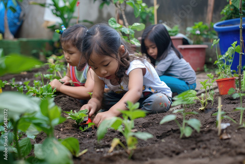 Young little kids planting plants in home backyard garden