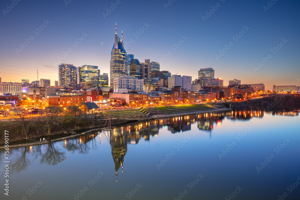 Nashville, Tennessee, USA. Cityscape image of Nashville, Tennessee, USA downtown skyline with reflection of the city the Cumberland River at spring sunset.