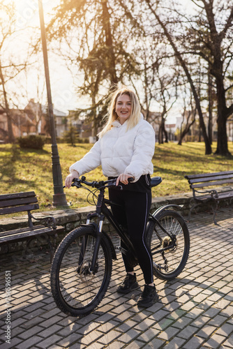 Woman Standing Next to Bike in Park