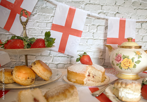 Celebrating St Georges day  England   afternoon team  vintage  victoria  sponge  strawberries and  cream scones bunting   england flag 