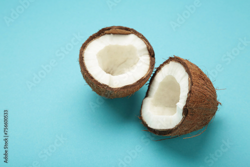 Coconut with half on blue background. Space for text photo