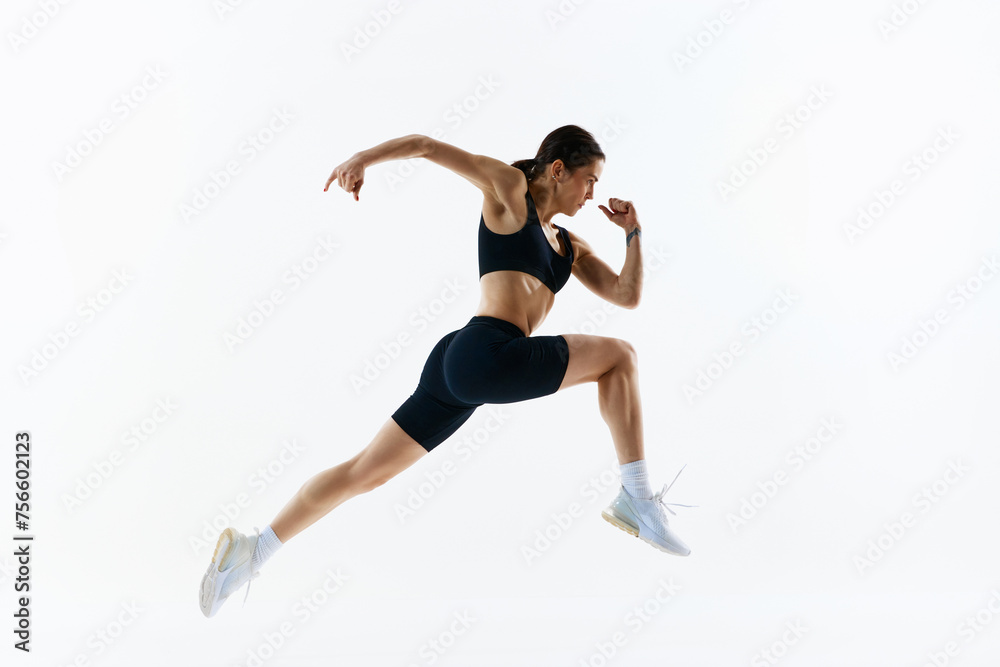 Dynamic image of young woman with strong, healthy, sportive body in sportswear in motion, training isolated over white studio background. Concept of sport, health and body care, fitness app Dynamic image of young woman with strong, healthy, sportive body in sportswear in motion, training isolated over white studio background. Concept of sport, health and body care, fitness app
