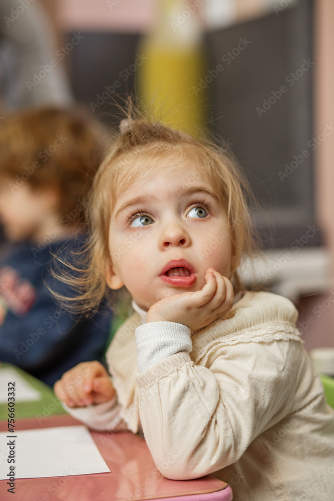 Thoughtful Toddler Girl During Classroom Activity Thoughtful Toddler Girl During Classroom Activity