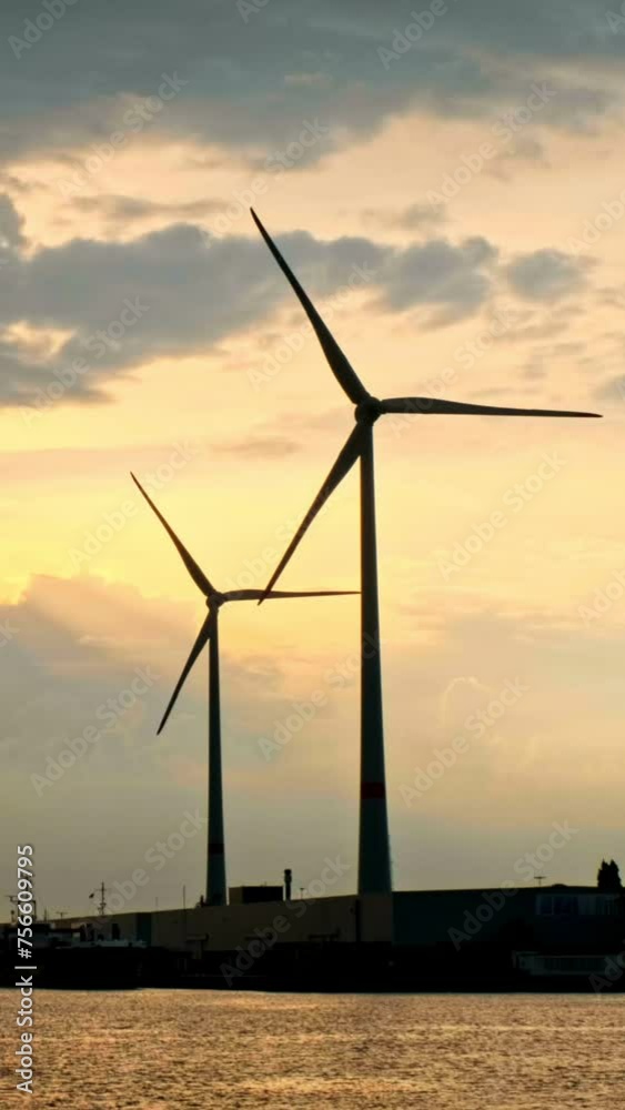 Wind turbines in Antwerp port on sunset. Antwerp, Belgium Wind turbines in Antwerp port on sunset. Antwerp, Belgium