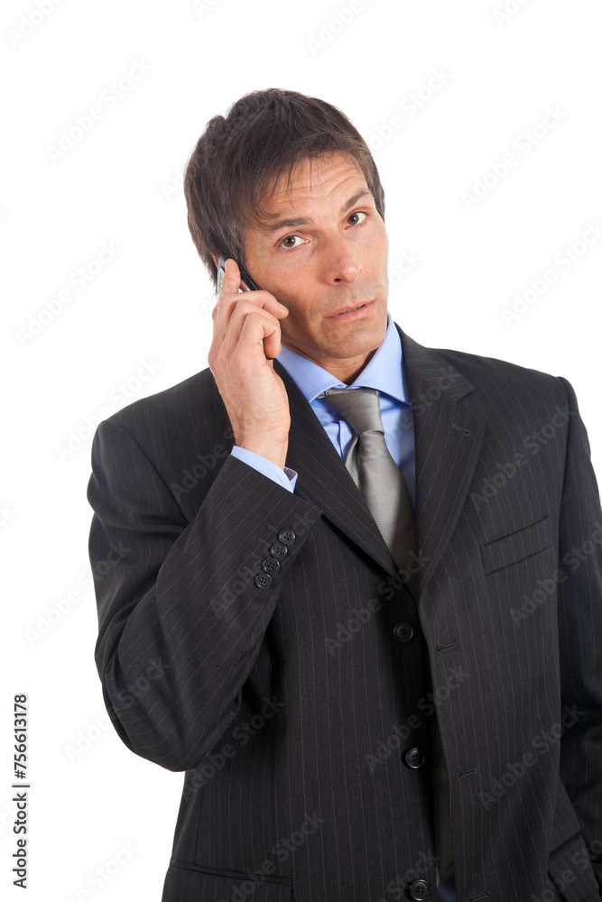 Businessman talking on mobile phone with a pensive look Businessman talking on mobile phone with a pensive look
