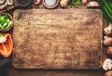 Vegan food and cooking background. Wooden cutting board, vegetables, spices and ingredients for preparing vegetarian Asian dishes with mushrooms and soy sauce. top view, copy space