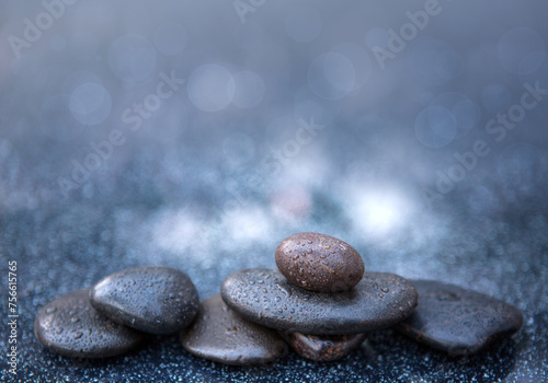 Black spa stones on the gray table background.