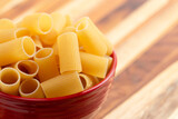 Raw Air Dry Rigatoni Pasta on a Wooden Table