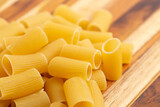 Raw Air Dry Rigatoni Pasta on a Wooden Table